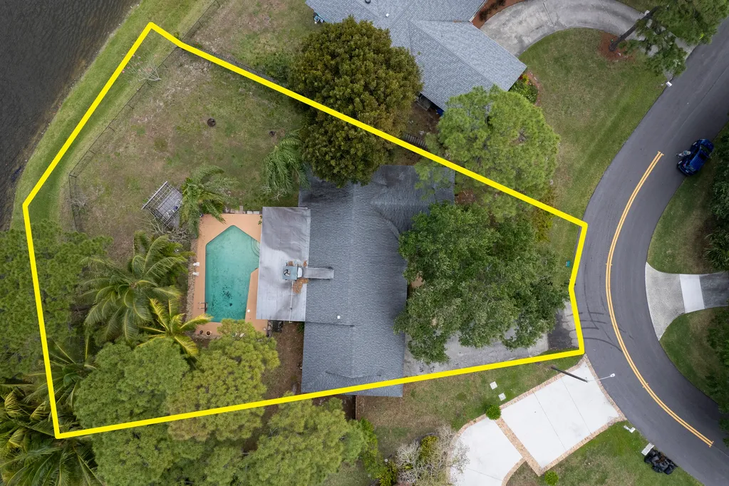 Aerial view of a sold waterfront pool home lot in Palm Beach Gardens, outlined in yellow