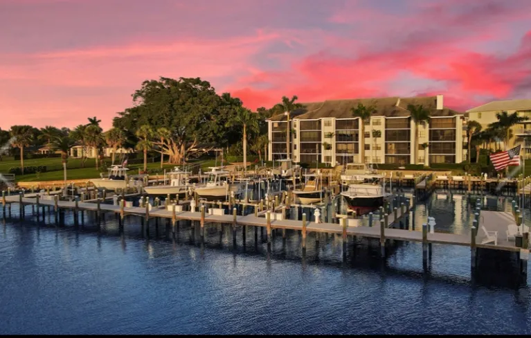Pink sunset over a waterfront condominium community and marina